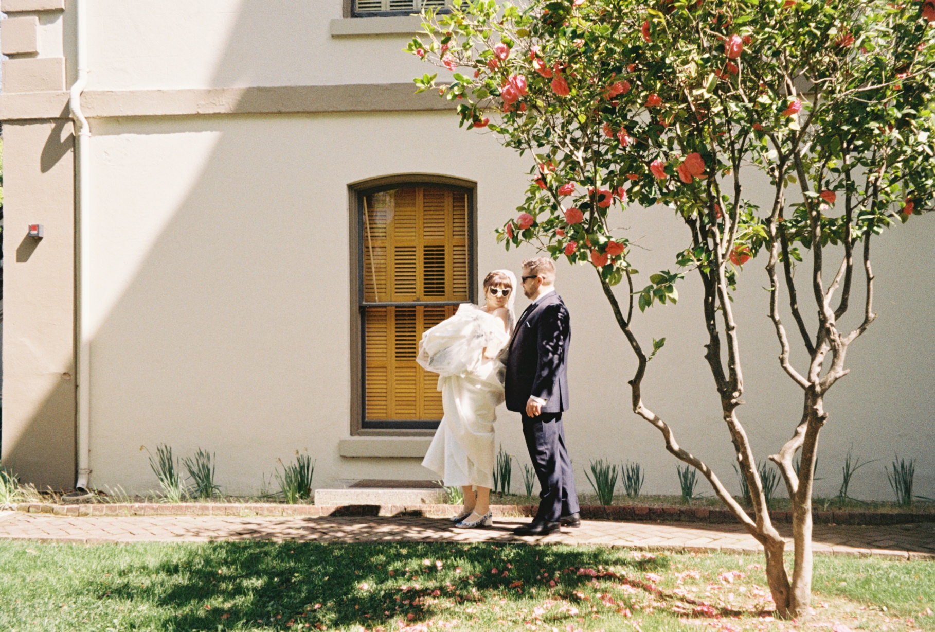 Married couple pose for the camera with cute heart shaped glasses making kiss faces at the camera.